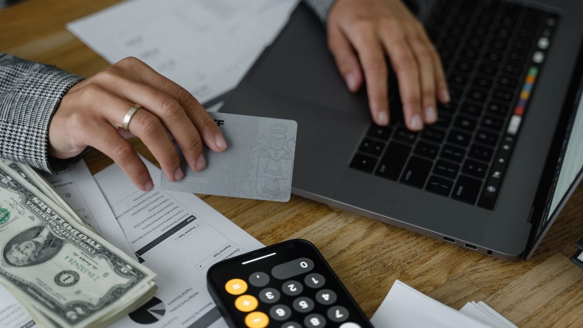 A calculator and a credit card on a desk, working out how to pay for a treatment