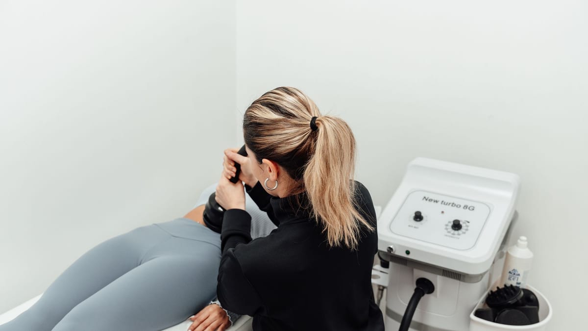 A body contouring device in use at a med spa, the equipment behind an Emsculpt NEO quote