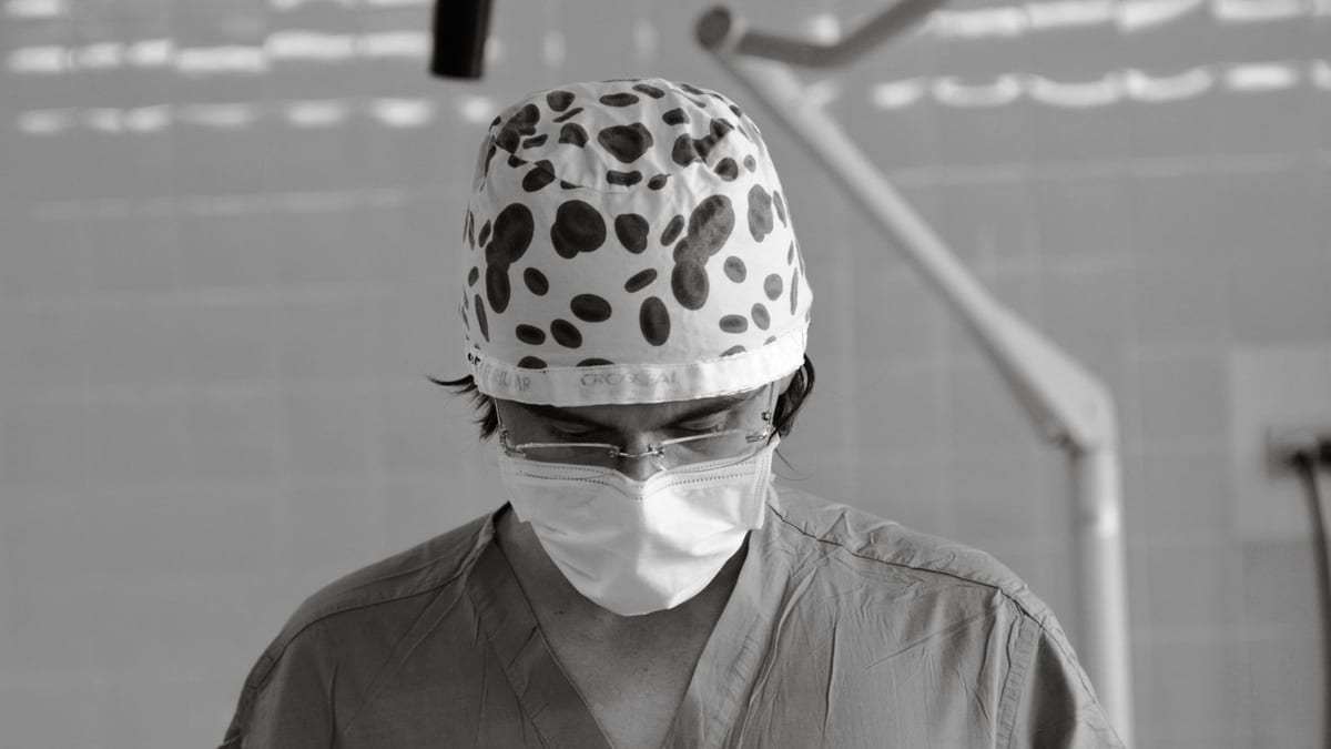 A surgeon in a white coat at a clinic