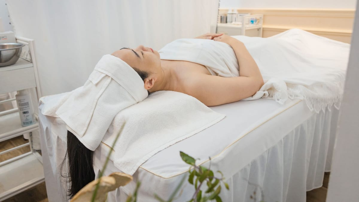 An empty spa treatment room with folded towels