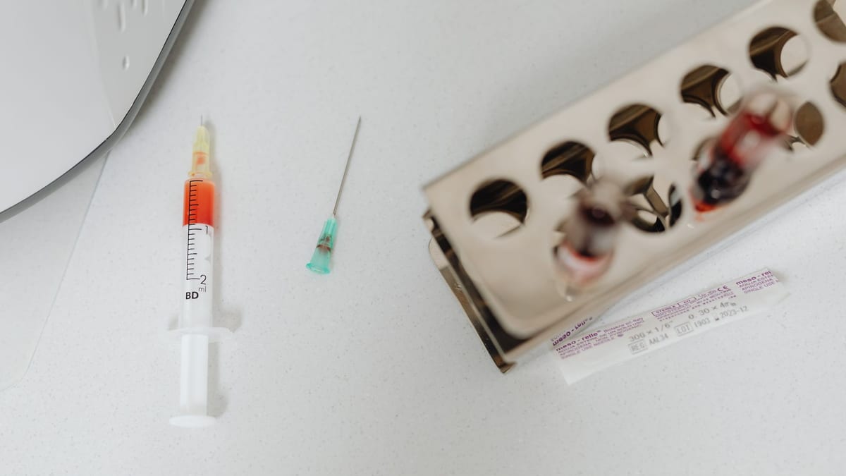 Syringes and vials on a cosmetic clinic tray