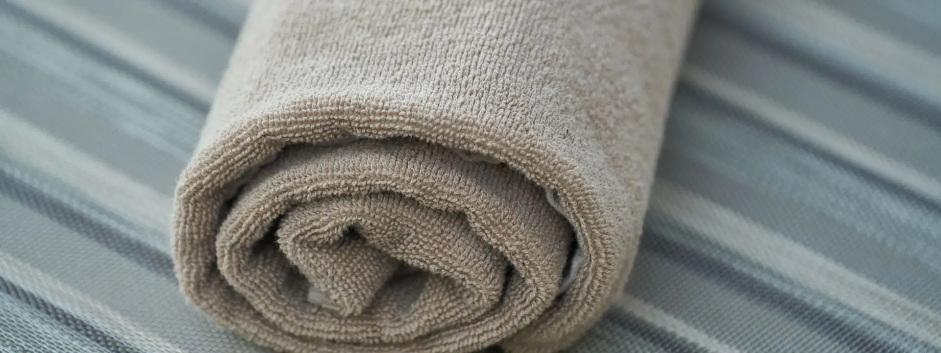 Rolled spa towel on a treatment bed