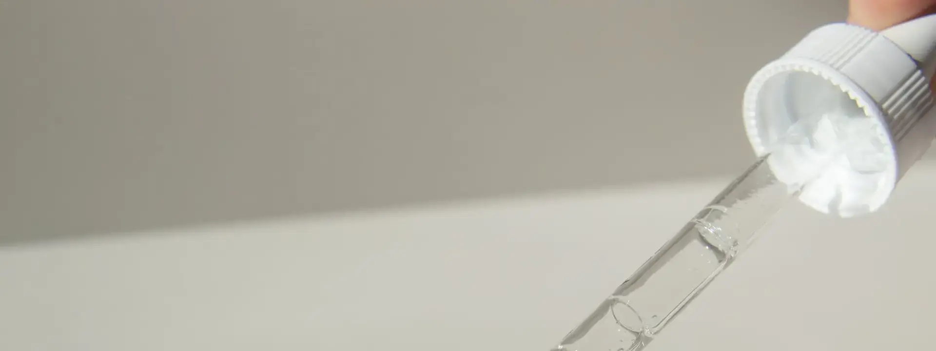 Skincare serum being drawn into a dropper