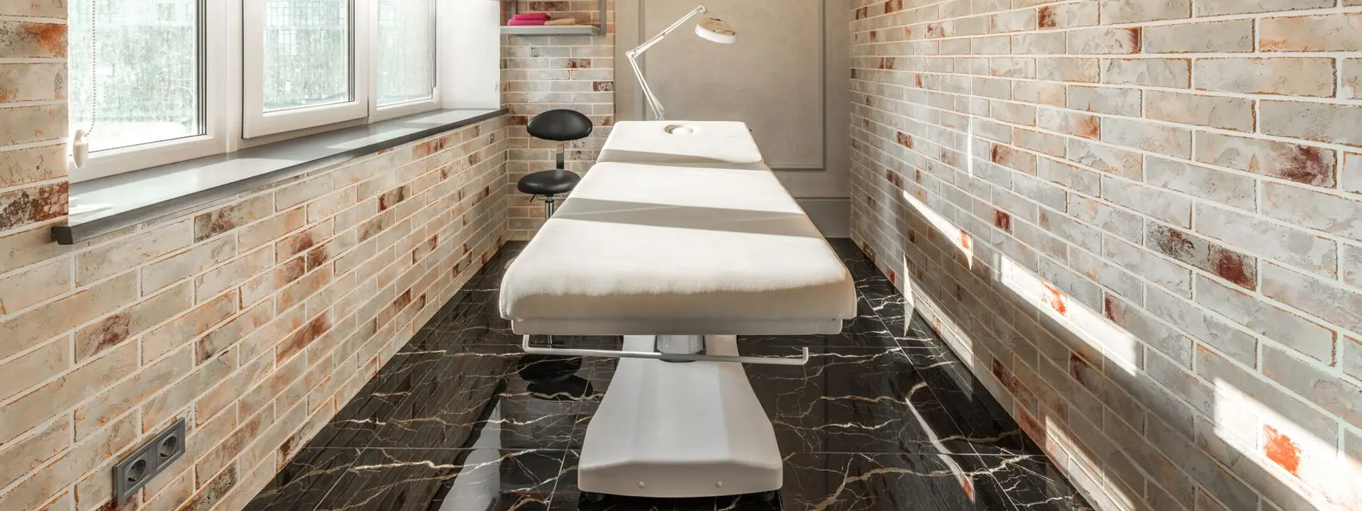 Calm aesthetic treatment room with a treatment bed